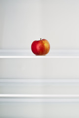 Apple in an empty fridge