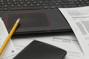 laptop computer and smartphone with important documents