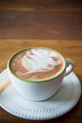 coffee cup and strawberry cake in coffee shop  with wood backgro
