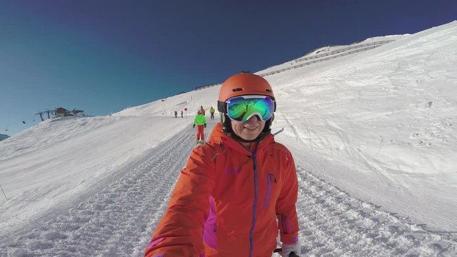 4k footage, four skiers skiing on small ski slope on sunny winter vacation day
