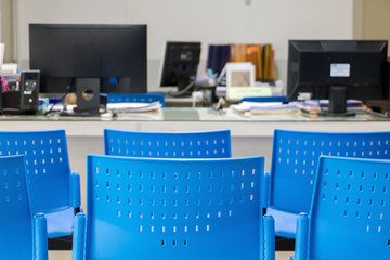 The empty chair before a desk with a computer in the office.