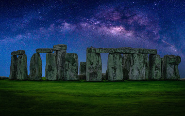 Fototapeta premium Landscape image of Milky way galaxy at night sky with stars over Stonehenge an ancient prehistoric stone monument, Wiltshire, UK.