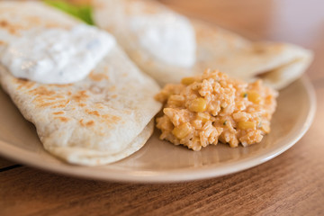 Enchilada with Mexican rice served on a plate.