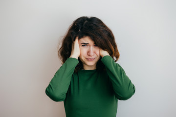 Young woman with headache, migraine, stress, insomnia, hangover on a light background - 136344314