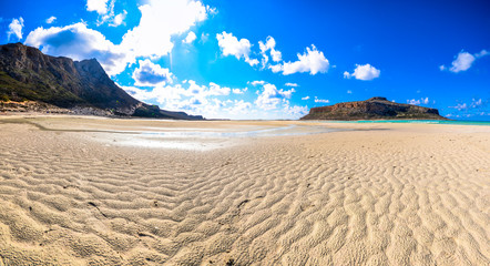 Amazing panorama of Balos Lagoon with magical turquoise waters, lagoons, tropical beaches of pure white sand with sea shells and Gramvousa island on Crete, Greece