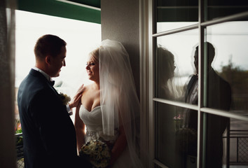 Happy beautiful newlyweds on the balcony outside