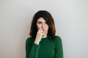 Portrait of a cunning girl on a light background