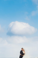 Beautiful romantic newlyweds posing outside