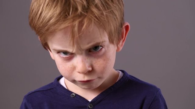 mad little boy staring, expressing anger for kid rebellion