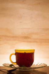 cup of tea shot against a backlit wooden background 