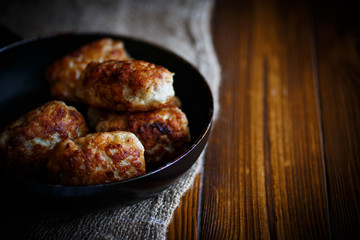 fried pork chops in a frying pan