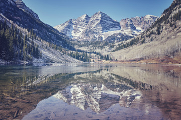 Retro color toned Maroon Bells mountain lake landscape, Aspen in Colorado, USA.