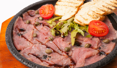 red fish with toast in a frying pan 