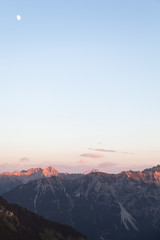 Scenic View of Mountain Panorama with Alpenglow in the Evening 
