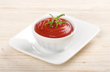 ketchup or tomato sauce on a wooden background