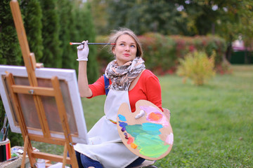 Women beautiful painter posing and smiling, laughing into camera