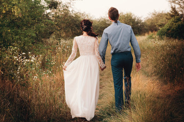 Couple having a date, holding hands and kissing or hugging.Unrecognizable people, closeup of legs.