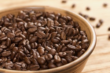 coffee beans in bowl on a wooden background