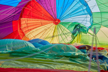 Hot air balloon inflating inside view, man shadow in backlight