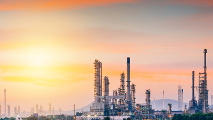 Fototapeta premium Aerial view oil refinery night with mountain background during twilight,Industrial zone,Energy power station.