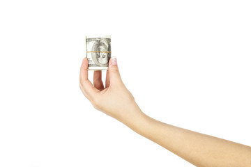 Female hand with twisted stack of dollars on white background.