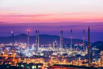 Fototapeta na wymiar Aerial view oil refinery night with mountain background during twilight,Industrial zone,Energy power station.