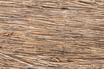 mat of old brown reeds, horizontally wall