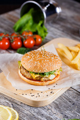 burger with mushrooms and chop on a wooden stand