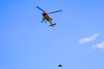 Fototapeta na wymiar Helicopter in Flight on a Blue Sky