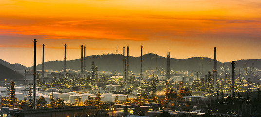 Aerial view oil refinery night with mountain background during twilight,Industrial zone,Energy power station.