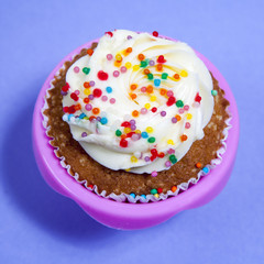 Cupcakes with white cream on the blue background,