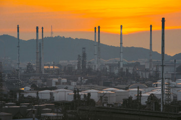Fototapeta premium Aerial view oil refinery night with mountain background during twilight,Industrial zone,Energy power station.