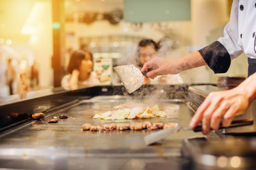 Hand of man take cooking of meat with vegetable grill.