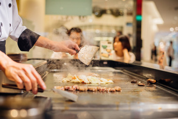 Hand of man take cooking of meat with vegetable grill.