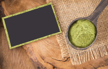 Moringa powder on wooden spoon