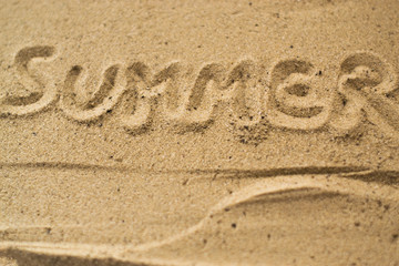 Macro Summer inscription on the sand at the beach