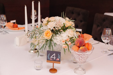 Wedding guest table decorated with bouquet and settings