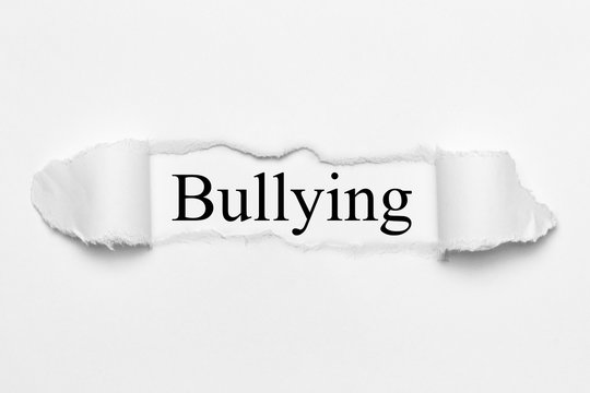 Bullying on white torn paper