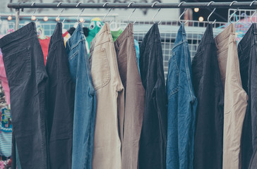 A rack of a variety of blue denim jeans in various shades of blu