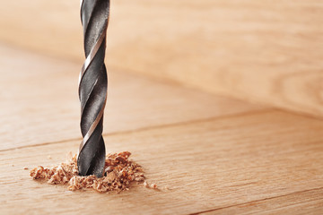 metal drill bit make holes in wooden oaks plank - Powered by Adobe
