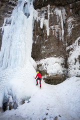 The climber climbs on ice.