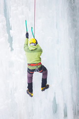 The climber climbs on ice.