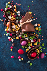 Fototapeta na wymiar Delicious chocolate easter eggs ,bunny and sweets on dark blue background