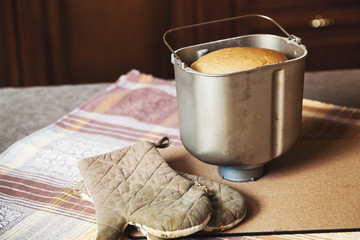 Form for baking bread and cooking gloves on table cloths