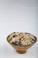 A mix of 4 types of rice. White cotton tablecloth background. 