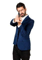 Fototapeta premium Handsome man holding a pistol