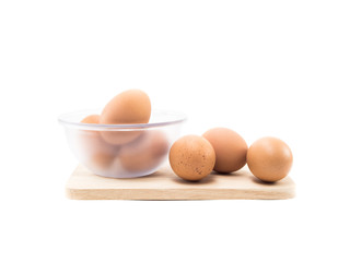 three eggs and eggs in cup on wood square isolated on white background