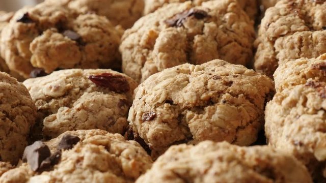 Homemade chocolate chip cookies pile close-up slow pan 4K 2160p 30fps UHD footage - Shallow DOF oatmeal biscuits served on plate 3840X2160 UltraHD panning video 