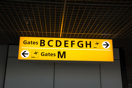 Illuminated sign at airport with gate numbers