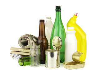 Collection of household recyclable items, isolated on white background. Includes paper, plastics, metal, and glass.